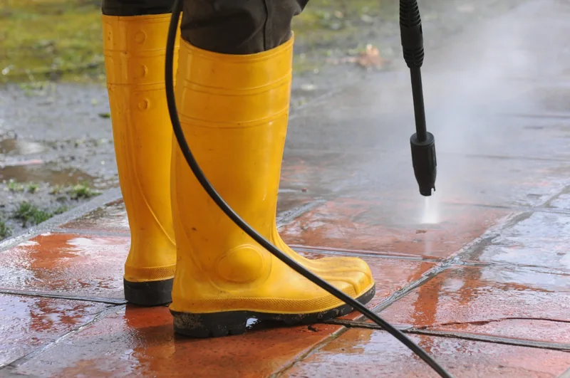Pressure washer cleaning a driveway